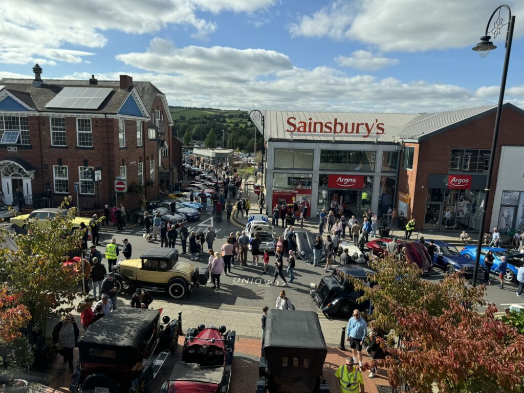 A photo of the Classic Vehicle Show taken from the window of the Town Hall Council Chamber looking out across the frontage into the street in front of Sainsburys