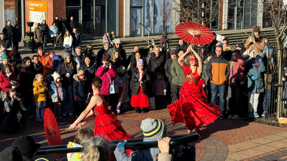 Dancers at the front of the Town Hall with a crowd of people surrounding them