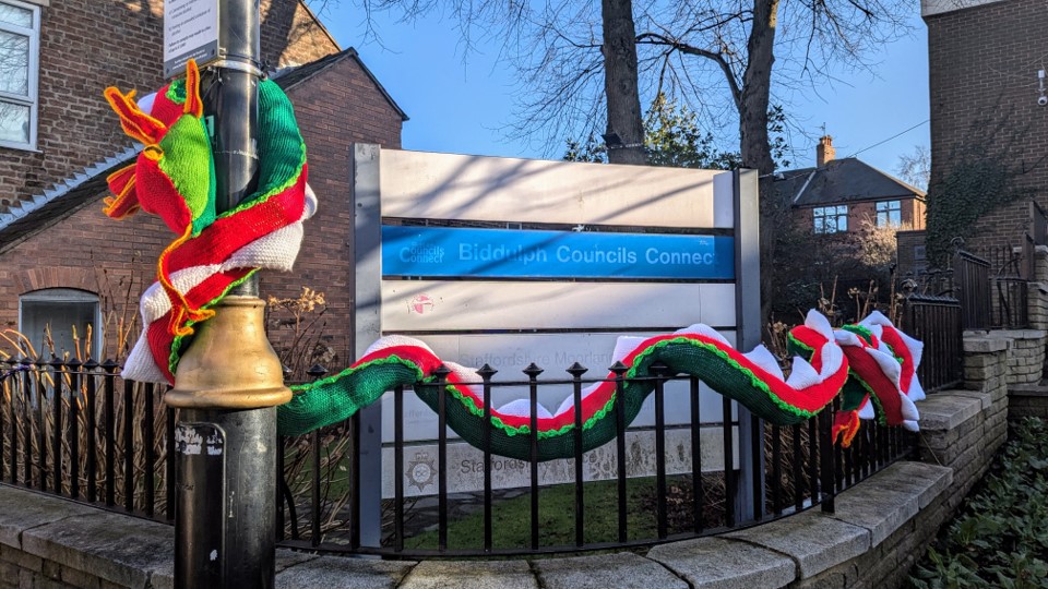 A snake curling round the railings at the front of the Town Hall made by Biddulph Yarnbarms