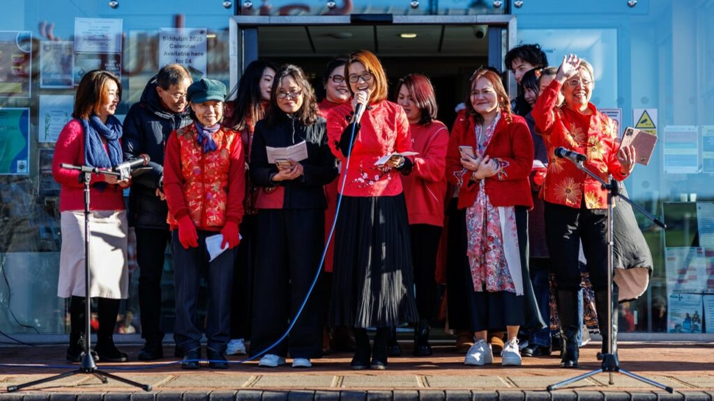 Members of Chinese Christian Fellowship performing their Chinese New Year songs on the steps of the Town Hall