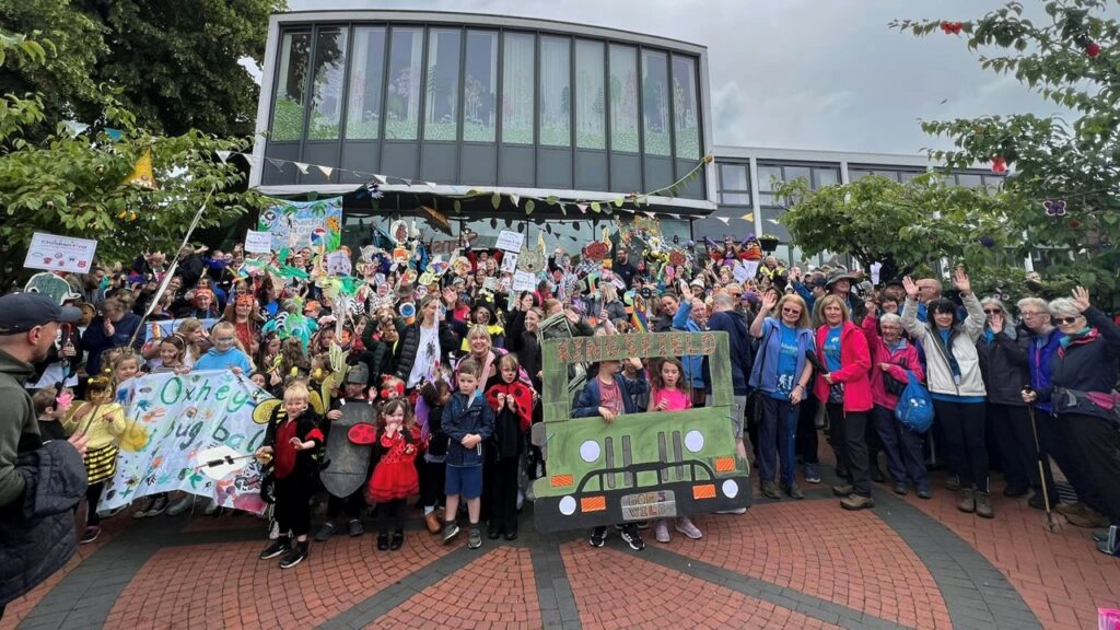 People involved in the festival standing on the steps of Biddulph Town Hall following the launch day parade