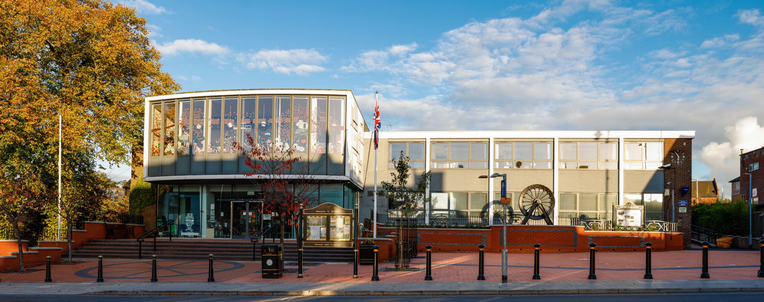 Image of the Town Hall Frontage with the mining wheel raised onto a brick plinth on the right hand side
