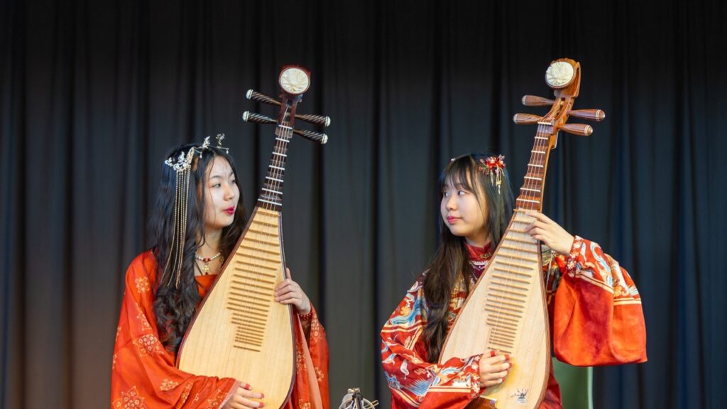 Traditional Chinese musicians in vibrant red costume
