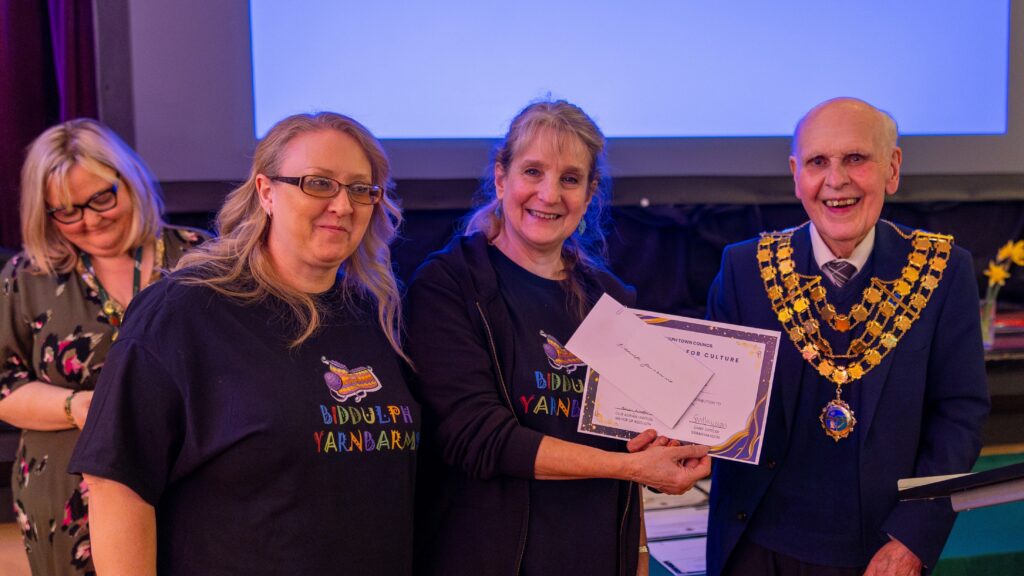 The Mayor presenting the Award for Culture to two representatives from Biddulph Yarnbarms