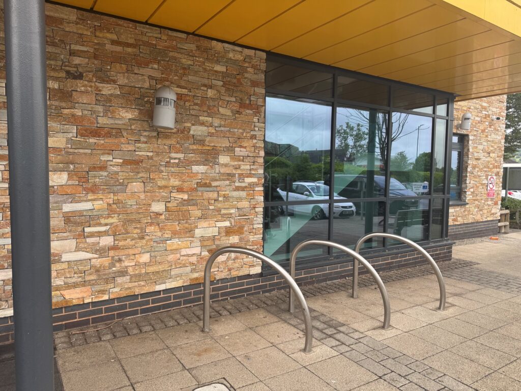 cycle racks outside the health centre in wharf road in front of the brick wall and window