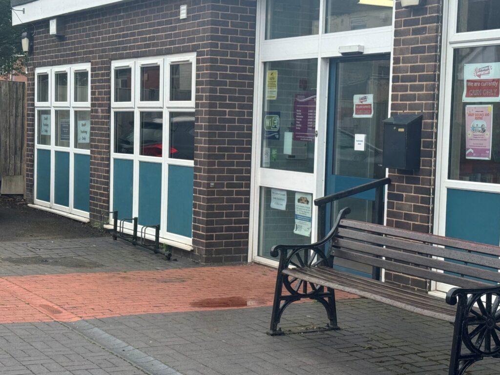 cycle racks outside biddulph library to the left of the entrance in front of the wall and window