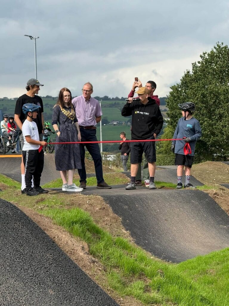 The Mayor, Councillor Charlie Smith, cutting the ribbon to open the new pump track